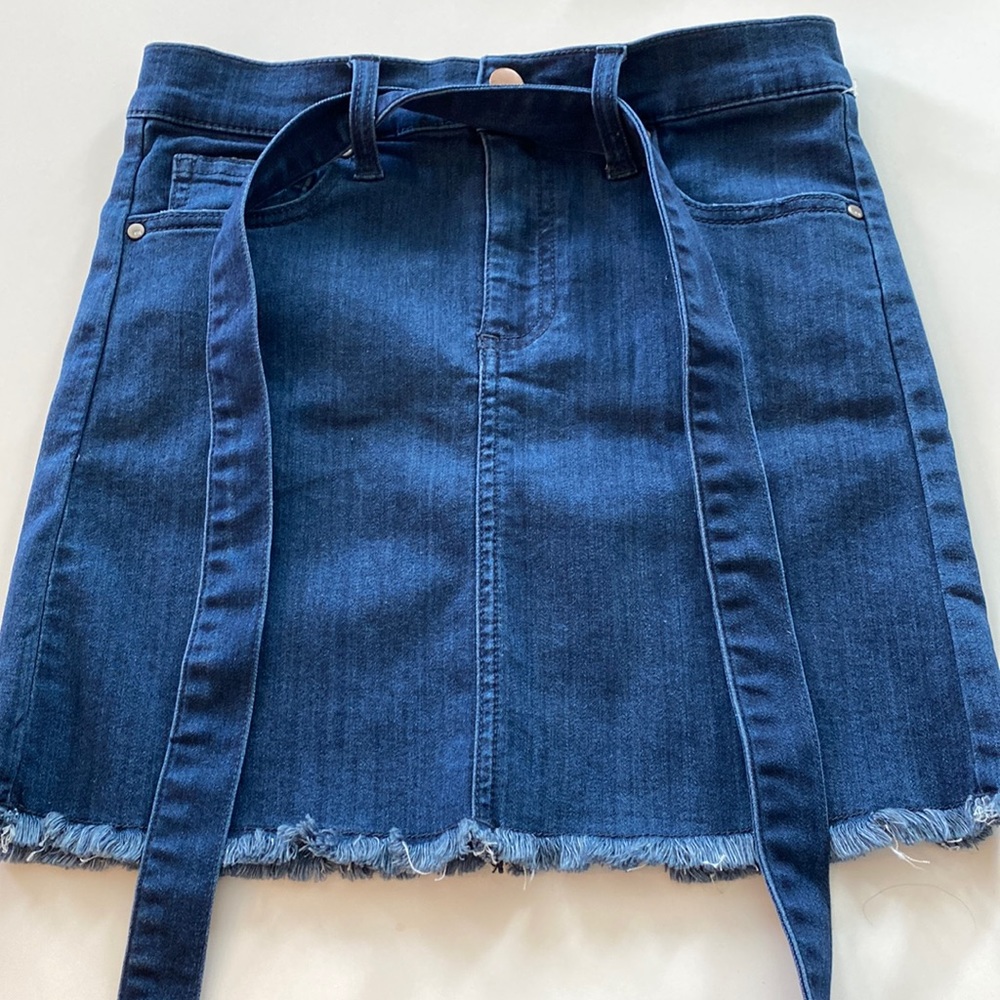 This denim dark blue skirt runs small at a size 14.